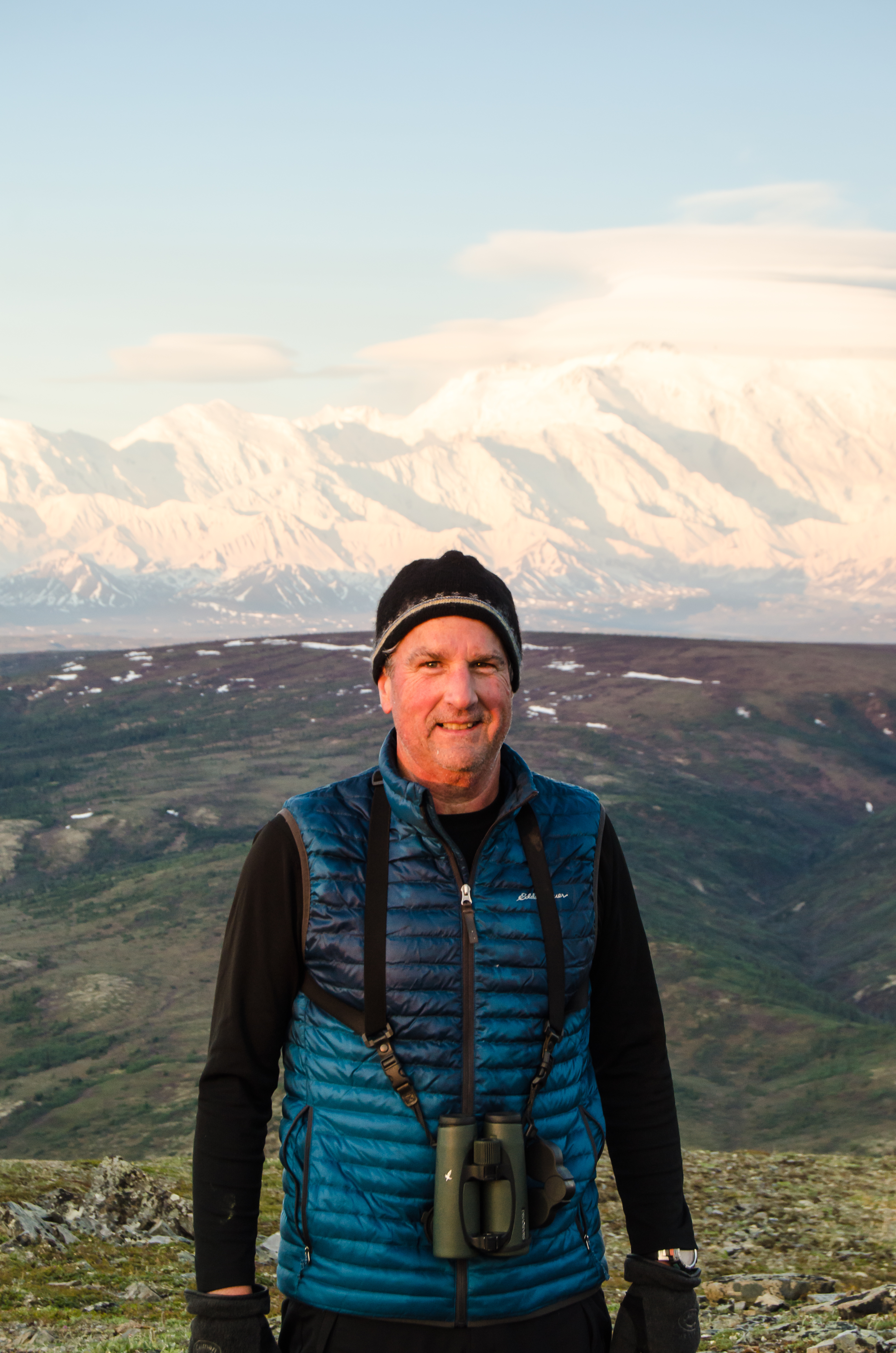 Man standing in front of a mountain.