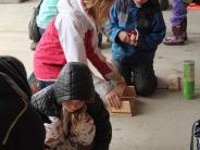 group of children building birdfeeders