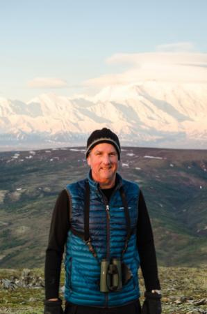 Man standing in front of a mountain.