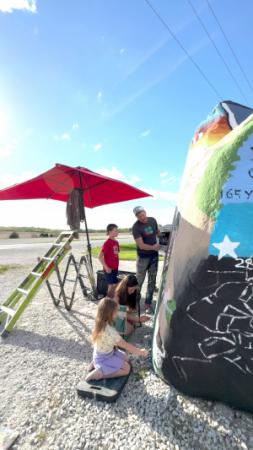 Bubba and his family painting a Freedom Rock Memorial