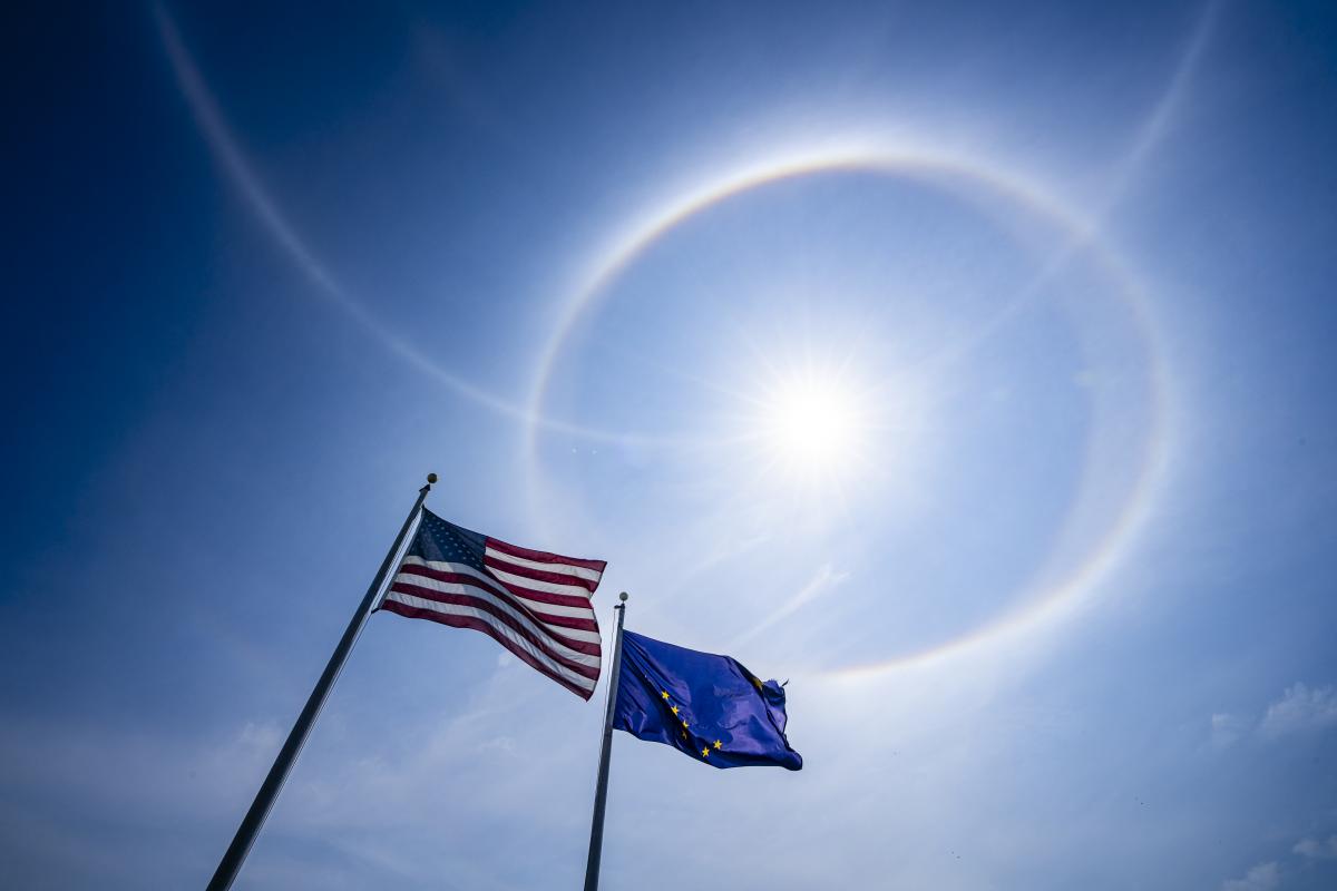 American and Alaskan Flags beneath the sun